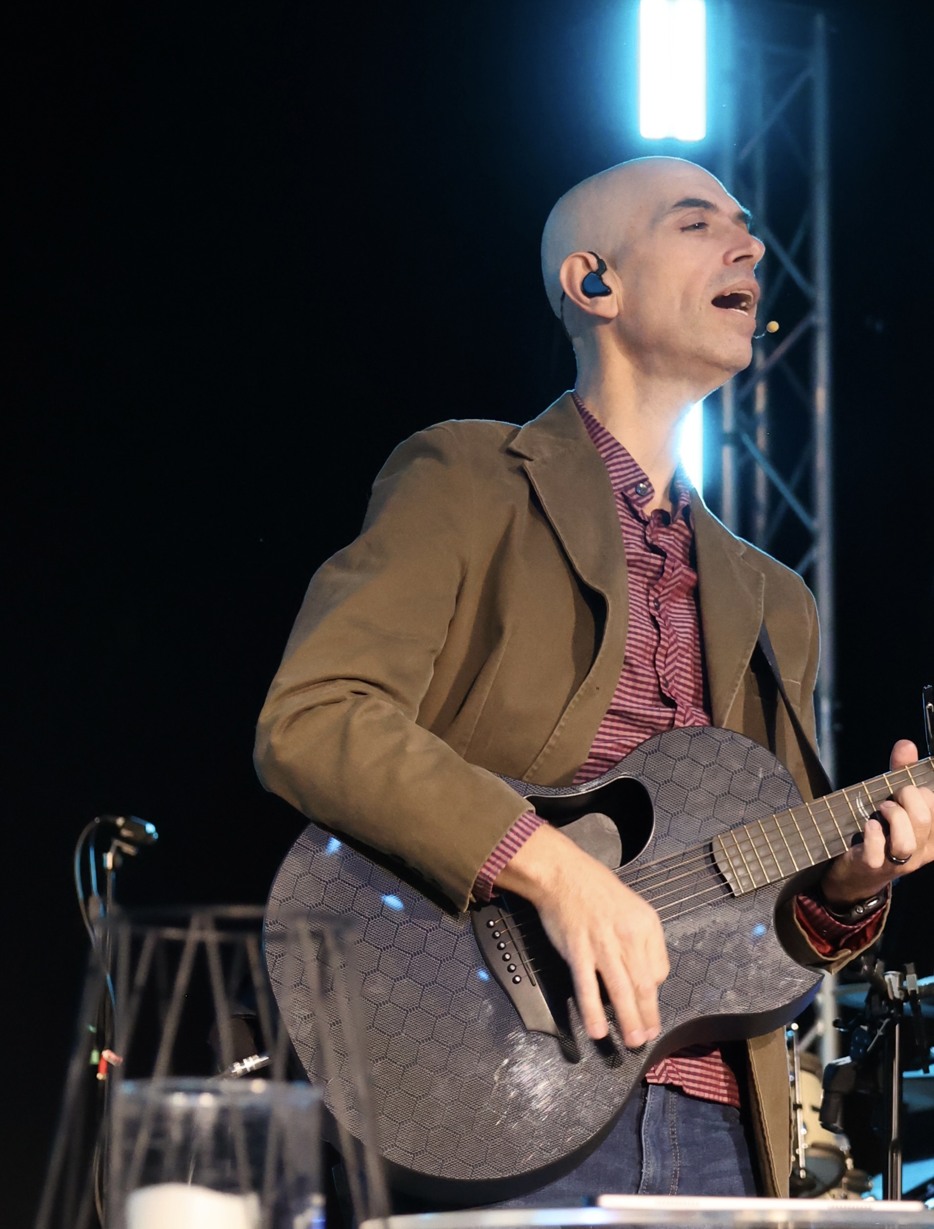 Chad singing and playing guitar on stage